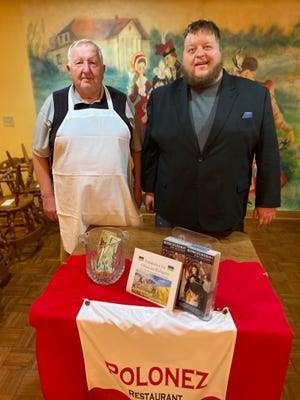 George Burzynski, left and his son, Peter, stand in front of a donation jar for the Kosciuszko Foundation at family-owned Polonez restaurant in St. Francis. The restaurant is working to find housing for a family of four Ukrainian refugees.