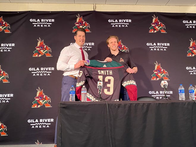 Arizona Coyotes General Manager Bill Armstrong and forward Nathan Smith hold Smith's new No. 13 jersey. Smith, a former Aberdeen Wing, signed a two-year, entry-level contract.