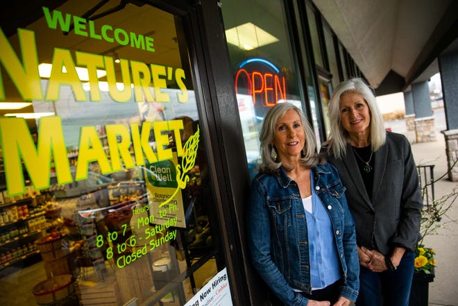 Nature's Market owners, Diane Slayer (left) and Theresa Hoerig (right), stand for a portrait Tuesday, April 13, 2022, at 1013 Washington Ave. in Holland.
