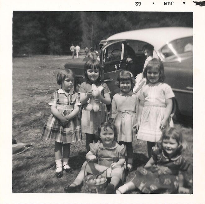 This 1962 photograph shows children displaying the spoils of an Easter egg hunt at a campsite at the head of Shope Creek.