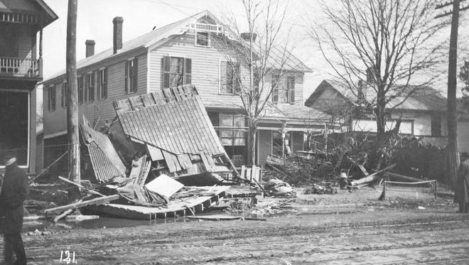 Trolley tracks and brick pavement can be seen in this photo of the 200 block of East State Street  in Fremont taken after the 1913 flood waters had receded. This area of the east side suffered extensive damage, as pictured here in the piled debris of wrecked structures. All the houses in this photograph have long since been gone, except the house whose corner appears at the left, which is now the Golden Dragon Chinese restaurant. (Submitted by Larry Michaels and Krista Michaels)