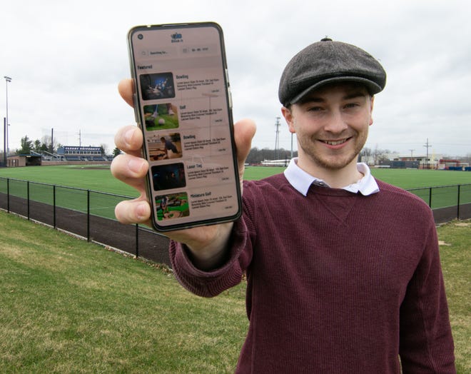 Cleary University graduate James Bell developed his app Book!t during the pandemic when he was the only student left housed in his dorm. Bell, shown Wednesday, April 13, 2022, moved to the U.S. from England to study and play soccer for the university. His app facilitates locating and booking activities, like bowling, miniature golf and laser tag.