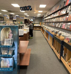 Customers shop at The Exclusive Company in Greenfield on Wednesday, April 13, 2022. The Wisconsin-based record store chain announced April 7 that it would be closing all its locations, but employees at the Greenfield store are attempting to buy the store and keep it open under a new name.