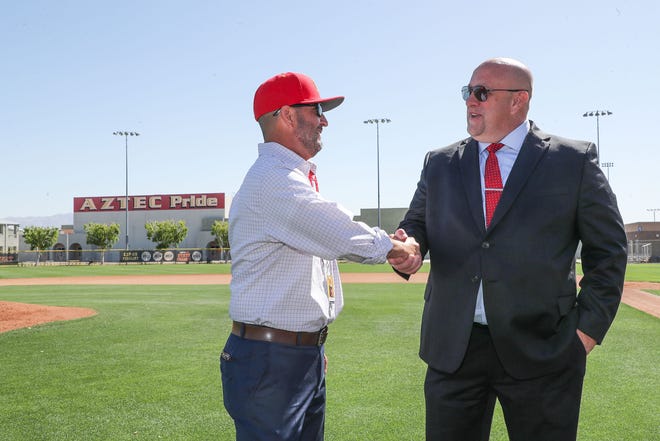 Palm Desert High School principal Dennis Zink, left, congratulates Estavan Valencia on being named the new athletic director and head baseball coach at Palm Desert High School in Palm Desert, Calif., April 13, 2022. 