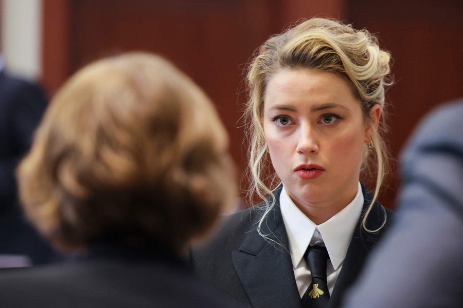 April 13, 2022:  Amber Heard speaks with her legal team as she attends Johnny Depp's defamation trial against her at the Fairfax County Circuit Courthouse in Fairfax, Va.