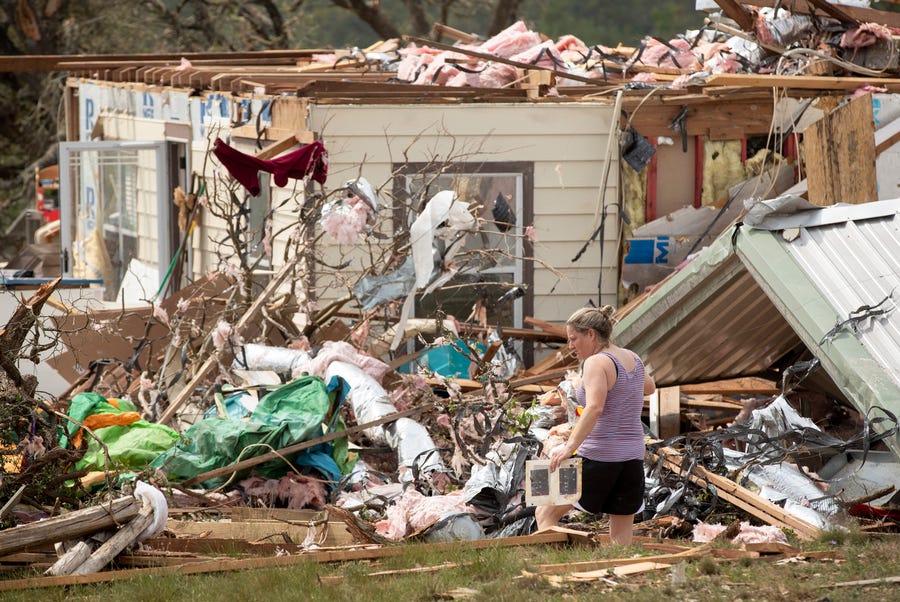 Michelle Light salvages belongings from her home on FM 2843 and Cedar Valley Road near Salado on Wednesday, April 13, 2022, a day after a tornado destroyed the house.