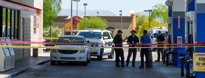 Phoenix Police Department officers at the scene of an officer-involved shooting at a gas station on the corner of Cave Creek and Beardsley roads on April 14, 2022, in Phoenix.