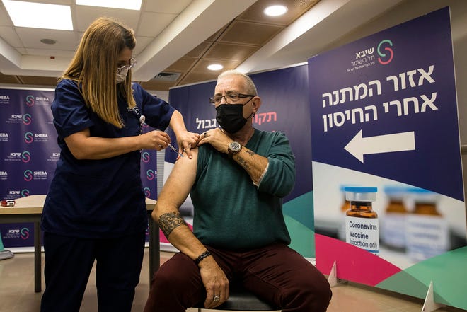 Heart transplant patient, Moshe Geva Rosso, receives a fourth dose of coronavirus (COVID-19) disease vaccine on Dec. 31, 2021, in Ramat Gan, Israel. Israel's Health Ministry approves a fourth vaccine dose for people with compromised immune systems. (Amir Levy/Getty Images/TNS)