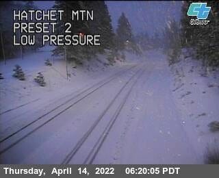 Caltrans said about 6:30 a.m. Thursday, April 14, 2022, that Highway 299 was blocked at Hatchet Mountain Summit, about 8 miles east of Burney, due to multiple spun-out big rigs in the area. A Hatchet Mountain traffic cam shows the highway covered in snow.