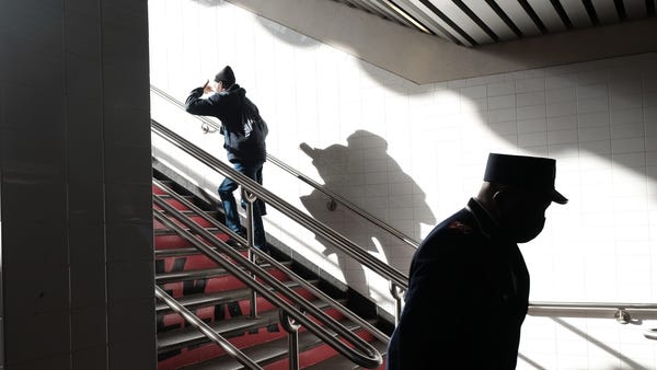 People enter and exit a Brooklyn subway station a 