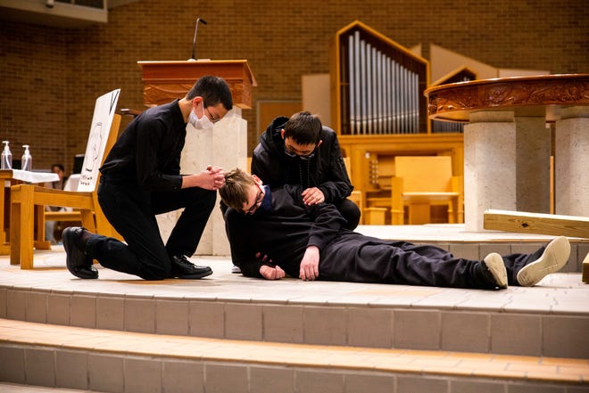 Students at Corpus Christi middle school reenact scenes during the stations of the cross prayer Friday, April 15, 2022, at St. Francis de Sales in Holland.