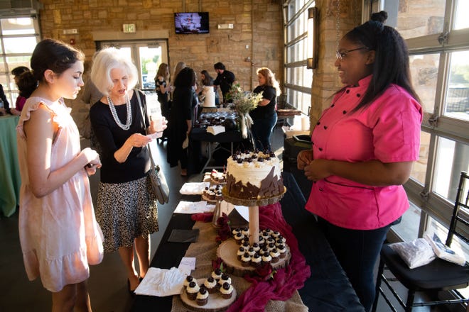 Kit Moss and her granddaughter Carter Brown sample chocolate from Jasmine Warren from Nova La Vega during the Death by Chocolate fund raising event for Counseling Service of West Alabama  Thursday, April 14, 2022, at Tuscaloosa River Market. Gary Cosby Jr./Tuscaloosa News  