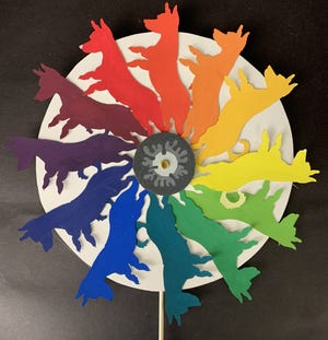 “Color Theory Pinwheel” by Mackenzie Johnson-Rees is artwork was created using Google Draw, a laser cutter, and mixing primary tempera paint colors.