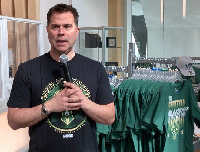 Milwaukee Bucks' senior vice-president Michael Belot models one of the new Bucks' 2022 NBA playoffs T-shirts while speaking at a news conference Thursday at the Bucks Pro Shop in Fiserv Forum.