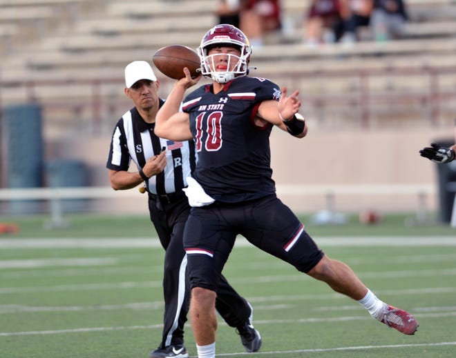New Mexico State quarterback Diego Pavia rolls out and completes a pass during Thursday's spring football game at Aggie Memorial Stadium.