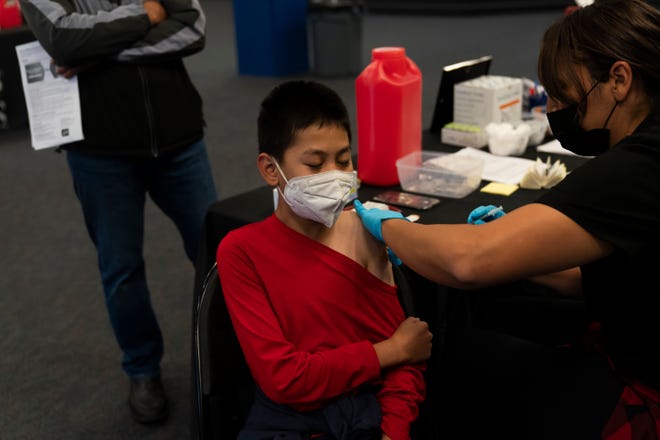 A youngster receives the Pfizer COVID-19 vaccine at a pediatric vaccine clinic for children ages 5 to 11 set up at Willard Intermediate School in Santa Ana, Calif., Nov. 9, 2021.