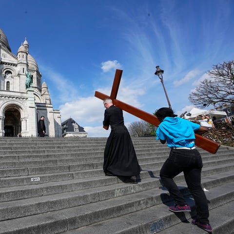 Faithfuls carry a wooden cross as part of Easter c