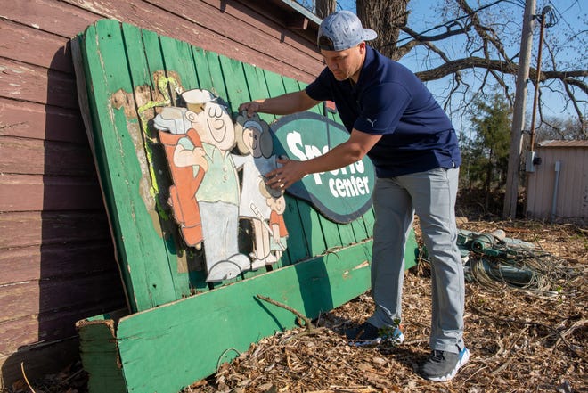 Showing how an old sign for the Sports Center once looked, new co-owner Kurt Walker says he's recovered many artifacts from the former 3-par golf course Friday afternoon. Walker, along with his brothers Scott, Brad and Brian, are in the process of bringing the course and fun center back to life under new ownership.