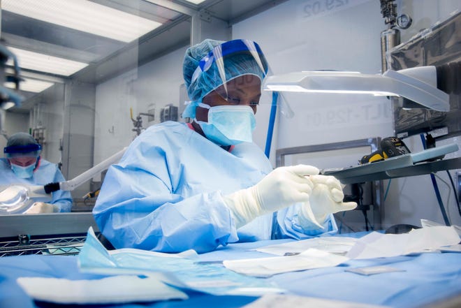 RTI Surgical employee works on implant at plant in Alachua. Contributed photo