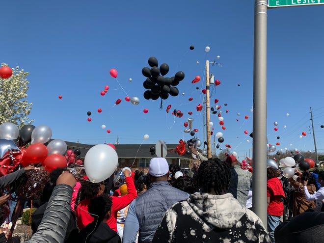 Family and friends release balloons to honor Michael Duerson III,16, after prayer