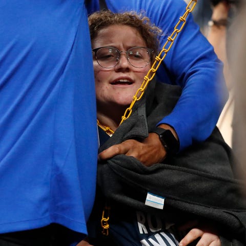 A protester chains herself to the basket during th