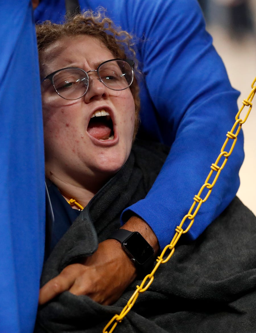 A protester chains herself to a basket during the first half of game one of the first round for the 2022 NBA playoffs at FedExForum.