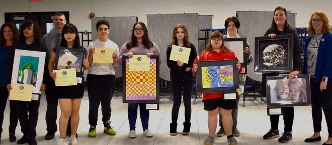 Art students from Springbrook Middle School and Adrian High School were recognized during the Adrian Public Schools Board of Education meeting April 11 for their accomplishments and successes in the Michigan Art Education Association K-12 regional art exhibition. Thirteen students were recognized. Pictured here, with their art pieces and certificates from the board are, from left, high school art teacher Victoria Beagle, Kaizar Johnson, Superintendent Nate Parker, Andrea Wong, Jaden Peterson, Natalie Ost, Madison Holey, Kendra Tucker, Caitlyn Tucker, high school art teacher Annie Howard and board President Beth Ferguson.