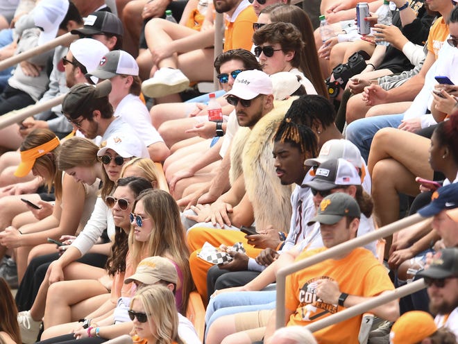 Tennessee basketball player Uros Plavsic wears a coat at the NCAA baseball game between Tennessee and Alabama in Knoxville, Tenn. on Sunday, April 17, 2022.
