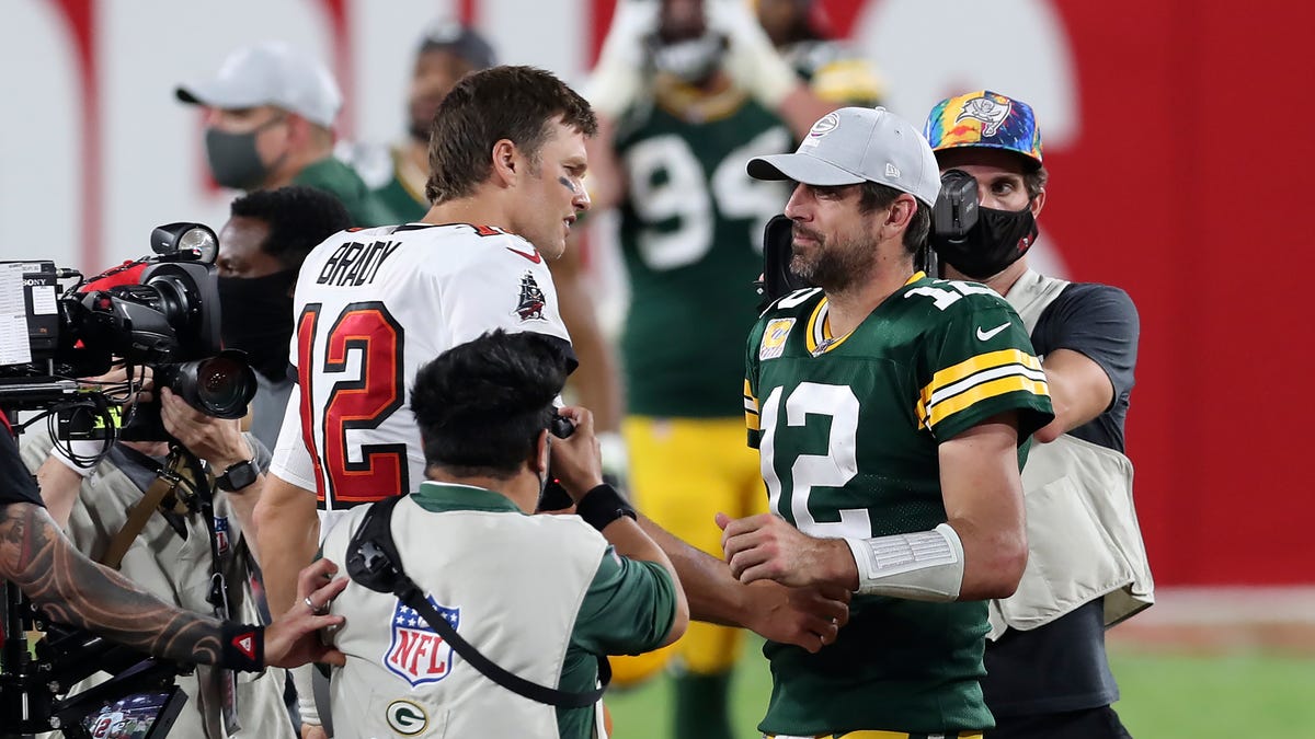 Tampa Bay Buccaneers quarterback Tom Brady, left, shakes hands with Green Bay Packers quarterback Aaron Rodgers after the Bucs defeated the Packers during an NFL football game Sunday, Oct. 18, 2020, in Tampa, Fla. (AP Photo/Mark LoMoglio)