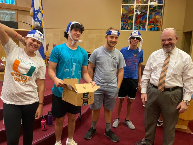 Temple Sinai hosted its first Passover Olympic Games on Sunday. Team Israel includes Alix Leinweber, Noah Leinweber, Gryffin Wilkens-Plumley, and Jackson Mitchell with Chazzan Cliff Abramson.
