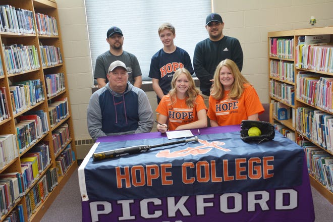 Lucy Bennin, front row center, signs with Hope College softball. Pictured front row, left and right are her parents Shawn and Angie Bennin; and back row, from left: Pickford coach Matt Hudecek, Gunner Bennin and Pickford athletic director Michael Collins.