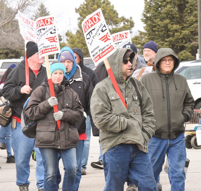 People rally outside the New Flyer plant Monday, April 18, 2022, in St. Cloud.