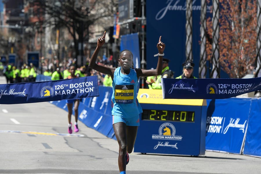 Peres Jepchirchir crosses the finish line in the women's division of the 2022 Boston Marathon