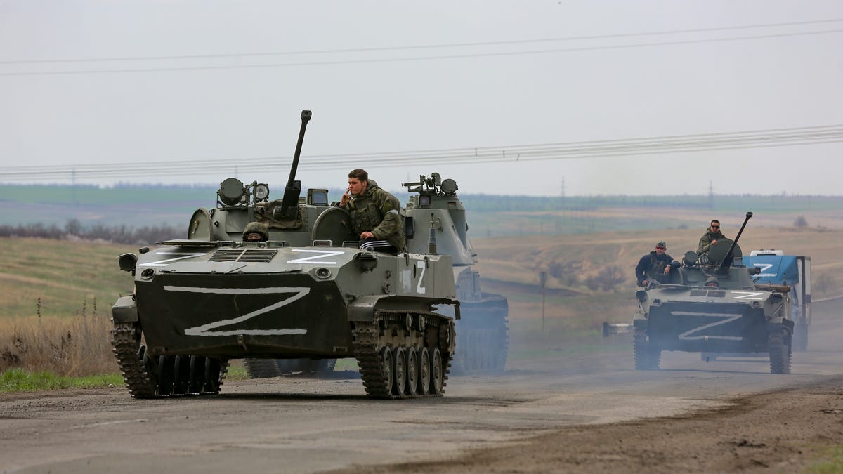 Russian military vehicles move on a highway in an area controlled by Russian-backed separatist forces near Mariupol, Ukraine, Monday, April 18, 2022. Mariupol, a strategic port on the Sea of Azov, has been besieged by Russian troops and forces from self-proclaimed separatist areas in eastern Ukraine for more than six weeks.