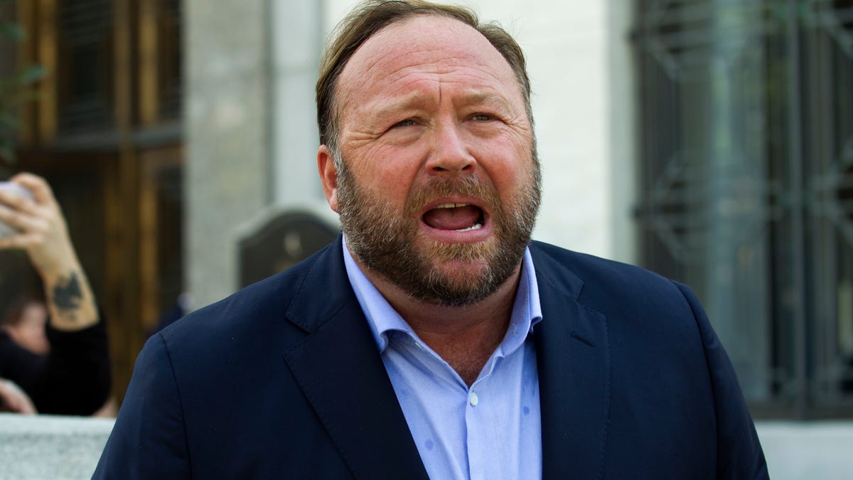 In this file photo, Alex Jones speaks to reporters in Washington, Sept. 5, 2018. Infowars filed for Chapter 11 bankruptcy protection on Sunday, April 17, 2022, in Texas as its founder and conspiracy theorist Alex Jones faces defamation lawsuits over his comments that the Sandy Hook Elementary School shooting was a hoax.