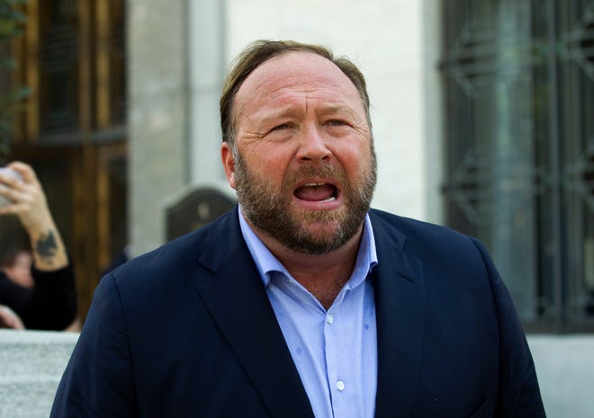 Alex Jones speaks to reporters in Washington in September 2018 after Infowars filed for Chapter 11 bankruptcy protection.