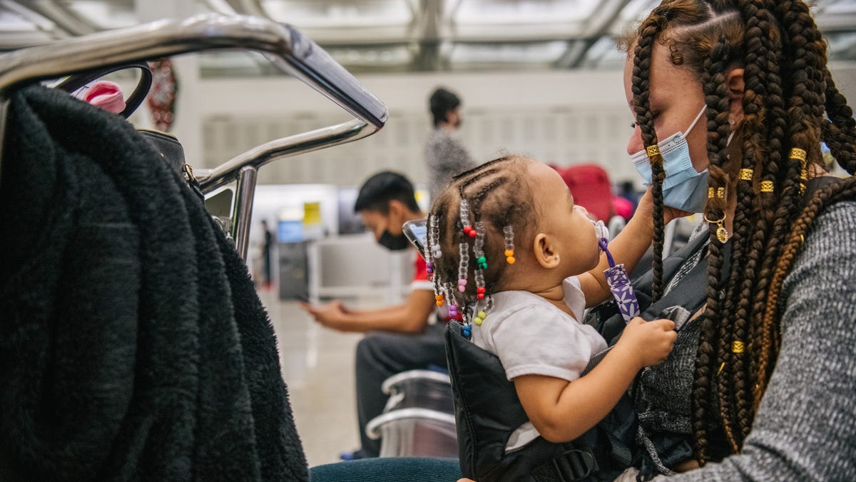 Karen Albicy bonded with her daughter Kaia while waiting for her PCR test to process at George Bush Intercontinental Airport on December 03, 2021 in Houston, Texas.
