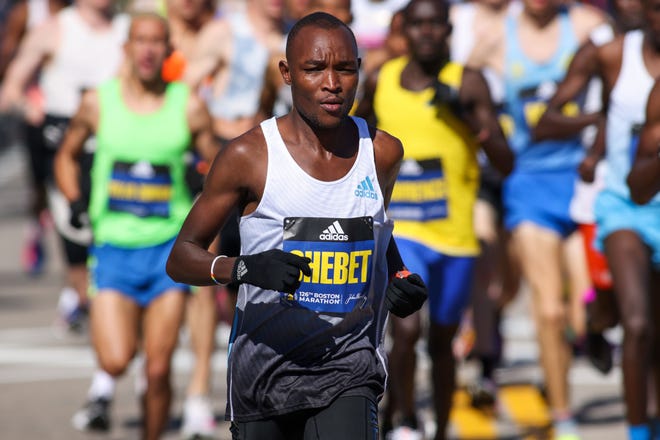 Evans Chebet, Peres Jepchirchir wen Evans Chebet (4) aims for the finish line in the men's division of the 2022 Boston Marathon.