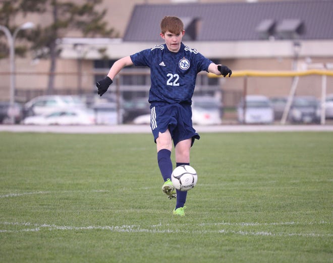 Notre Dame-West Burlington's defender Taylor Lundgreen dribbles to ball in Monday's 6-0 win over Hillcrest Academy at Tackleson Field.