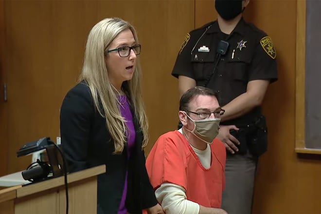 In this frame capture from an Oakland County courtroom, James Crumbley, right, listens to his lawyer in court as she requests a lower bond in front of Judge Cheryl Matthews on April 19, 2022. The request for a lower bond was denied.
