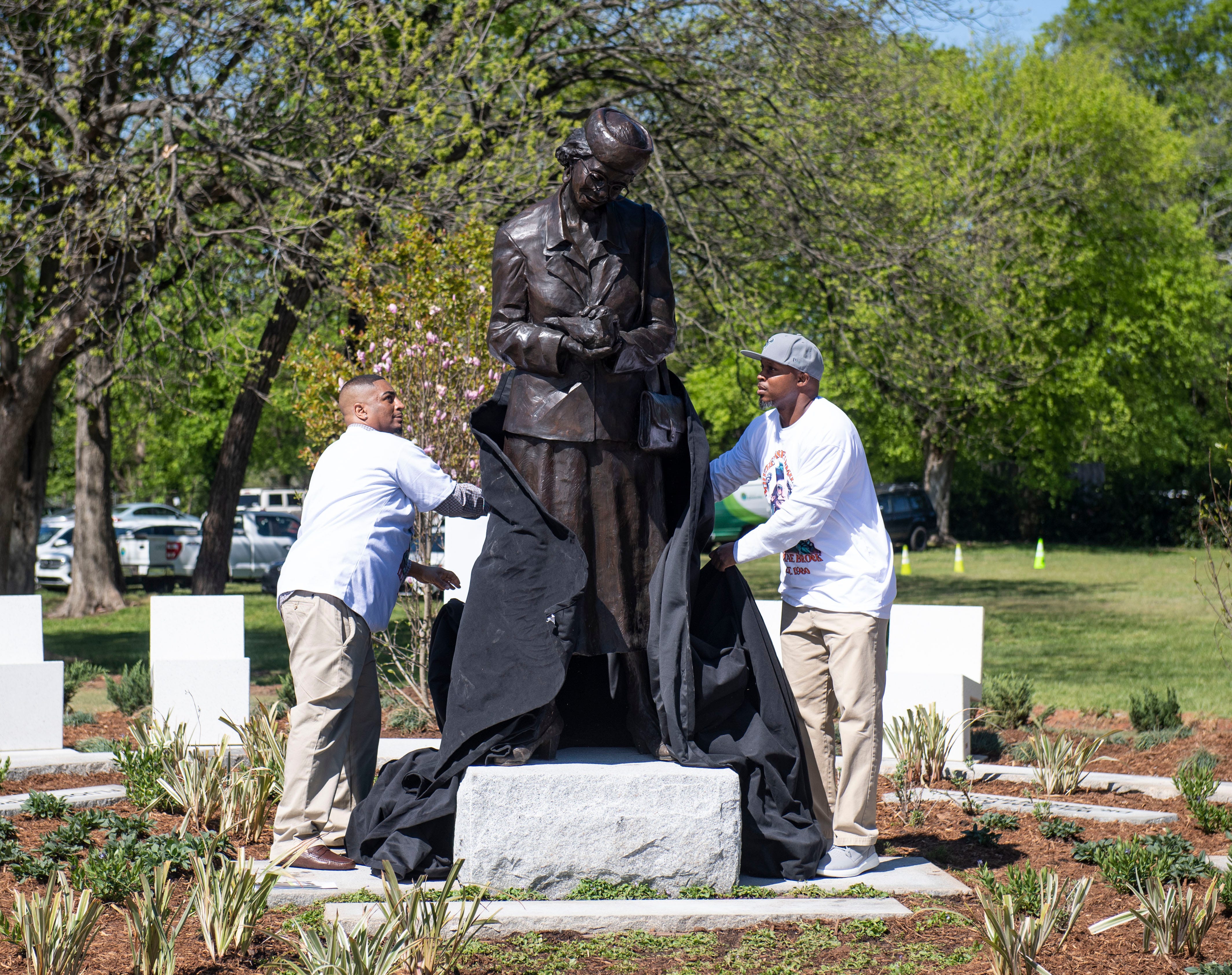 The unveiling of the Lila Mae Brock statue by artist Charles Pate Jr. during the dedication ceremony.