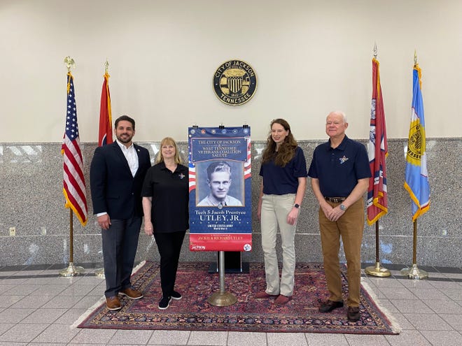 Jackson City Mayor Scott Conger (left), Jackie Utley, chair of the West Tennessee Veterans Coalition (second from left), Megan Holt, soldier and family readiness specialist with the West Tennessee Veterans Coalition (second from right), and veteran Larry Newsom (right), stand with the first banner of the project.