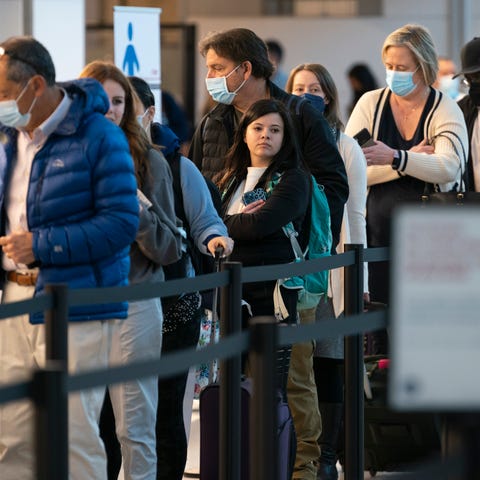 Passengers wait in line at the security checkpoint