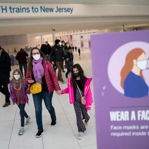 Mass transit riders wear masks as they commute in 