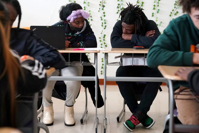 Shamara Kennedy, left, and Kendall Marcus-Riley, right, go over a class exercise during a lesson on Ohio House Bill 616 in Bethany Cole's 11th-grade social studies class, Monday, April 18, 2022, at Aiken High School in Cincinnati.