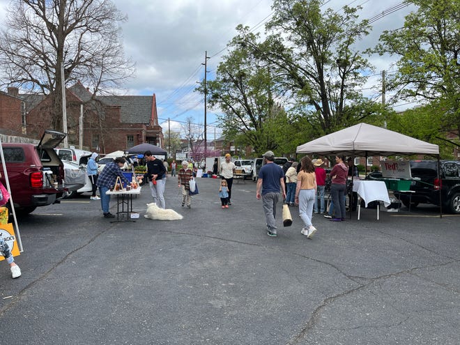 Almost all the vendors at the Highland's farmers market were serving customers.