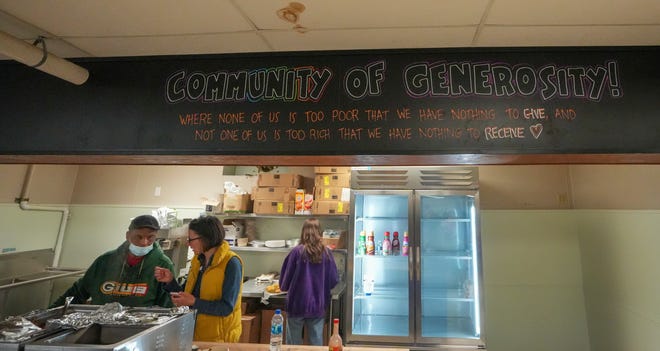 A sign at Kinship Community Food Center in Milwaukee's Riverwest neighborhood calls the center a "Community of Generosity."