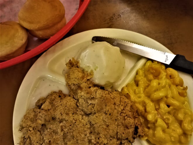 Pioneer 3 Chicken Fried Steak with mashed potatoes and white gravy, macaroni and cheese and rolls.