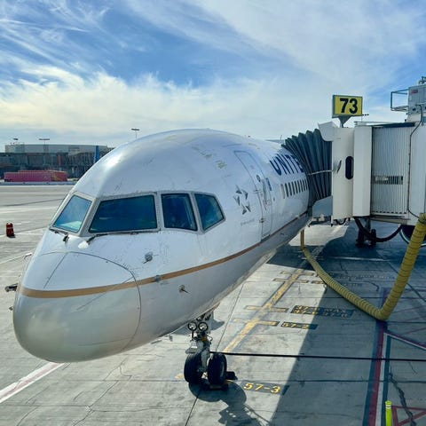 A United Airlines plane sits at a jetbridge at Los