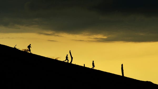 People race down the dunes at Warren Dunes State P